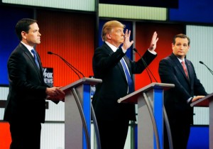 Republican U.S. presidential candidate Trump shows off the size of his hands as rivals Rubio, Cruz and Kasich look on at the start of the U.S. Republican presidential candidates debate in Detroit