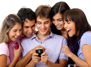Group of people social networking on a cell phone - isolated over white