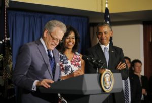 U.S. President Barack Obama and his wife Michelle stand with U.S. ambassador to Cuba, Jeffrey DeLaurentis (L), as they meet with embassy staff in a hotel in Havana March 20, 2016.  REUTERS/Carlos Barria - RTSBDKQ